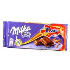 Шоколад Milka з шматочками карамелі Daim 100г